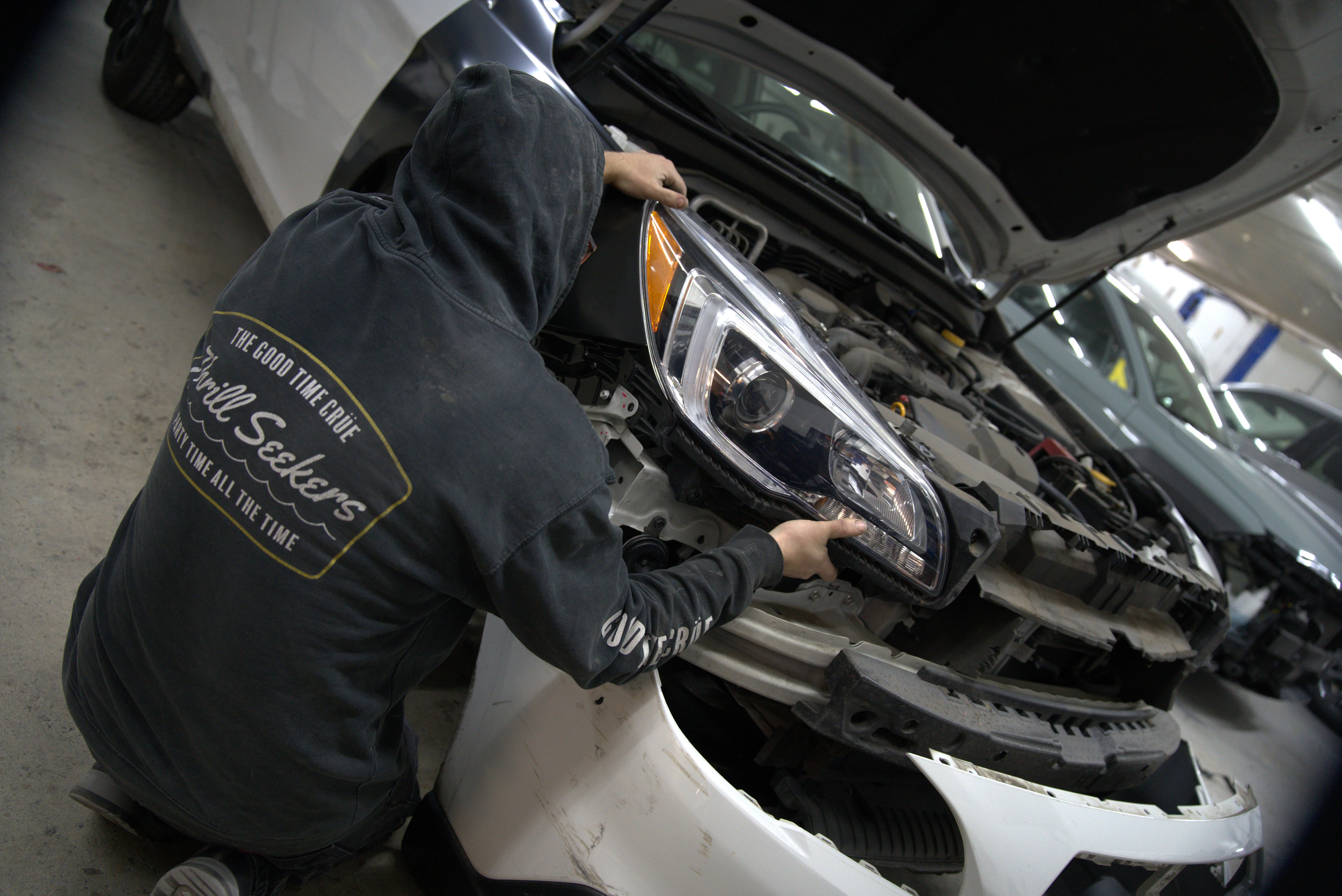 Hail damage repair Vancouver WA - Five Star Auto Body technician performing paintless dent removal on vehicle panel